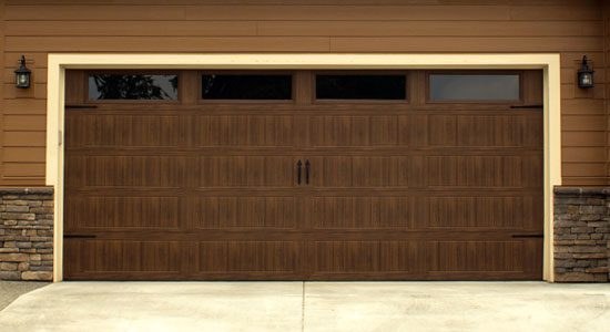 Classic steel garage door installed on a brick home