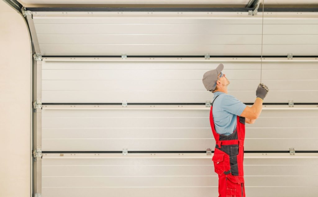 Technician Fixing a Noisy Garage Doors